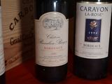 several bottles of wine are lined up on a table