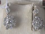 a pair of earrings that are sitting in a box