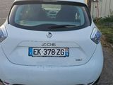 a small white car parked on the side of the road