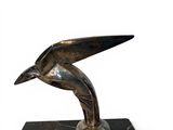 statue of a bird on a marble base on a white background