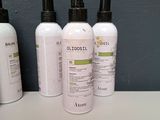 four bottles of body lotion sitting on top of a counter