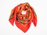 an orange scarf with a floral design on it