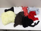 a white table topped with lots of clothes on top of it