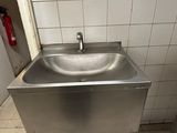 a sink in the corner of a public restroom