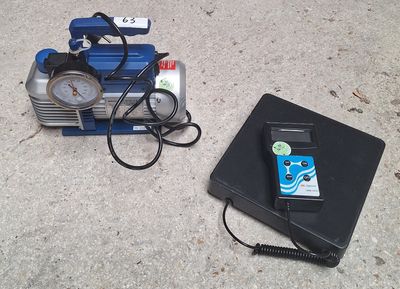 a cell phone sitting next to an air compressor on the ground