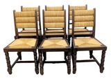four wooden chairs with wicker seats on a white background