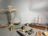 a scale, a hammer, a clock, and other objects on a table
