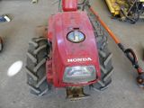 a picture of a red tractor parked in a garage