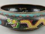 a black bowl with a dragon painted on it