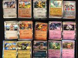 a lot of different pokemon cards on the table