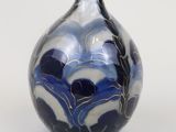 a blue and white vase sitting on a white surface