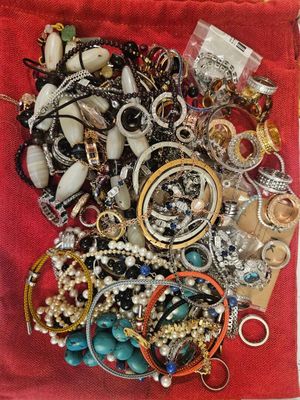 un sac rouge rempli de nombreux bijoux posé sur une table