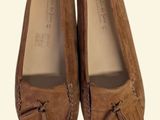pair of brown sued shoes with tassels on top of them