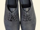 men ' s grey leather shoes with laces on a white background