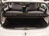 the back of a white car with its trunk open and the seats down