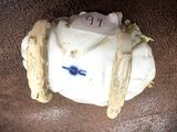 a white porcelain object with a blue bird on it