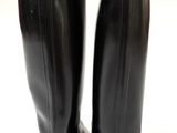 the back of a pair of black leather boots on a white surface