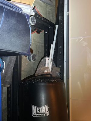 an image of a black punching bag in a garage