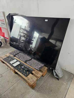 a flat screen tv sitting on a pallet on the floor