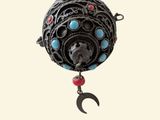 a black ball with a red and blue bead hanging from it ' s side