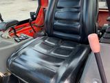 an image of a tractor seat with a steering wheel