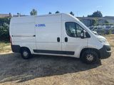 a white van parked in a parking lot next to a house