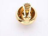 an image of a close up of a gold plated object on a white surface