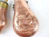 two copper objects on a white surface, one of which is a lighter and the other of which is a lighter