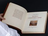 a person holding an open book with a picture on it