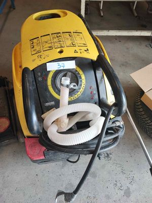 a yellow and black machine that is sitting in a garage