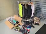 boxes of clothing and other items are on the floor in a storage area
