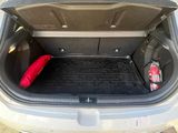 a trunk of a car with a red pillow in it