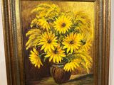 painting of a vase of sunflowers hanging on a wall