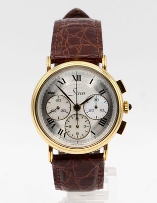 a close up of a wrist watch with roman numerals on it