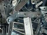a large pile of metal parts that are in a box