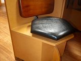 a chair that has a seat on it in front of a desk