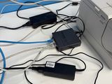 many wires connected to a printer sitting on a table