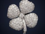 une image représentant une broche en forme de trèfle à quatre feuilles sertie de diamants