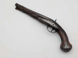 an old gun with a wooden handle on a white surface