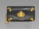 a black and gold purse with gold decorations on it