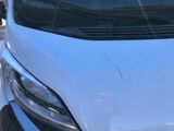 a close up of the front of a white van