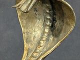 a gold cobra statue on display on a black surface