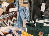 a pile of clothes and other items on a table
