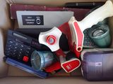 a cardboard box filled with assorted items including a laptop and a calculator