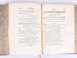 a book open on a white surface with writing on it