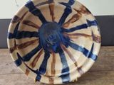 a blue and white bowl sitting on a wooden table