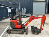 a small red excavator parked in a parking lot