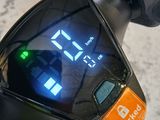 a close up of a bike with a digital clock on the handlebar