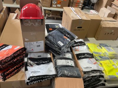 many boxes of clothing and a hard hat on a table