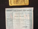 an image of a piece of gold sitting on top of a black table